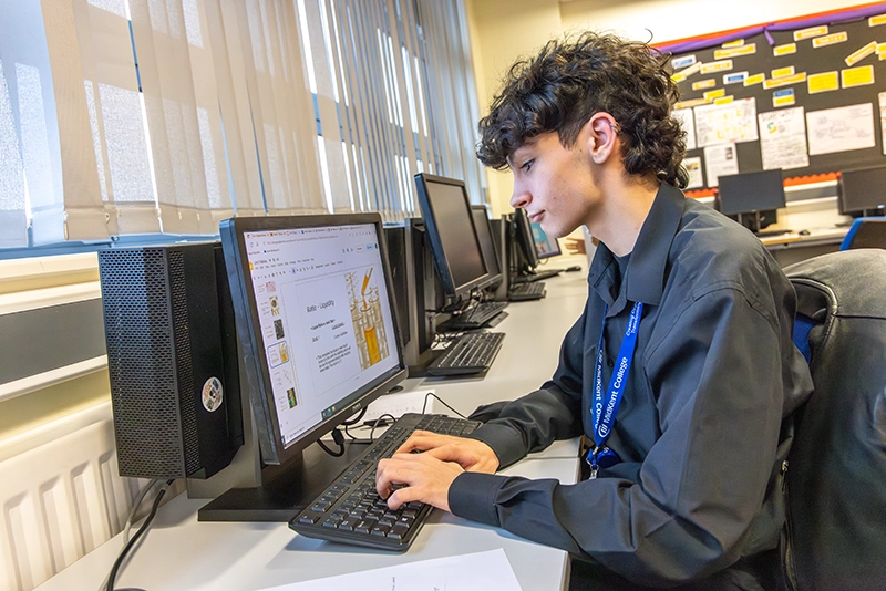 Student using computer equipment in classroom setting