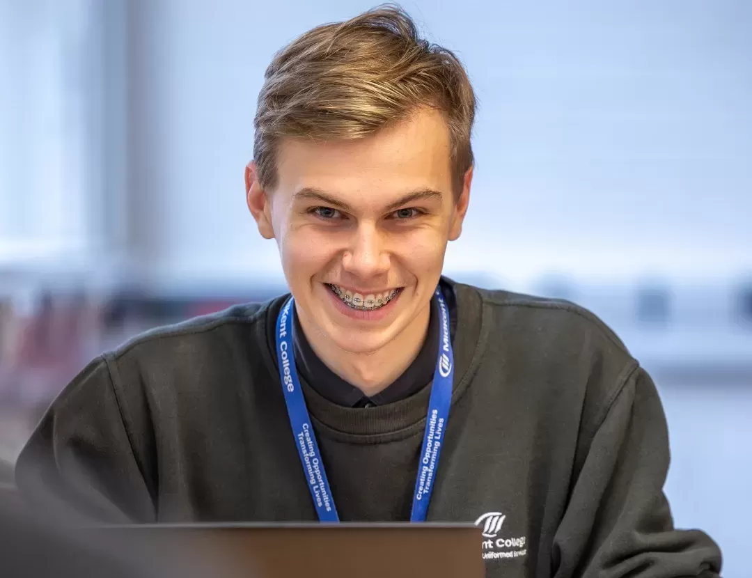 Student posing in classroom setting