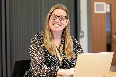 Marie Albrow poses for camera in classroom setting