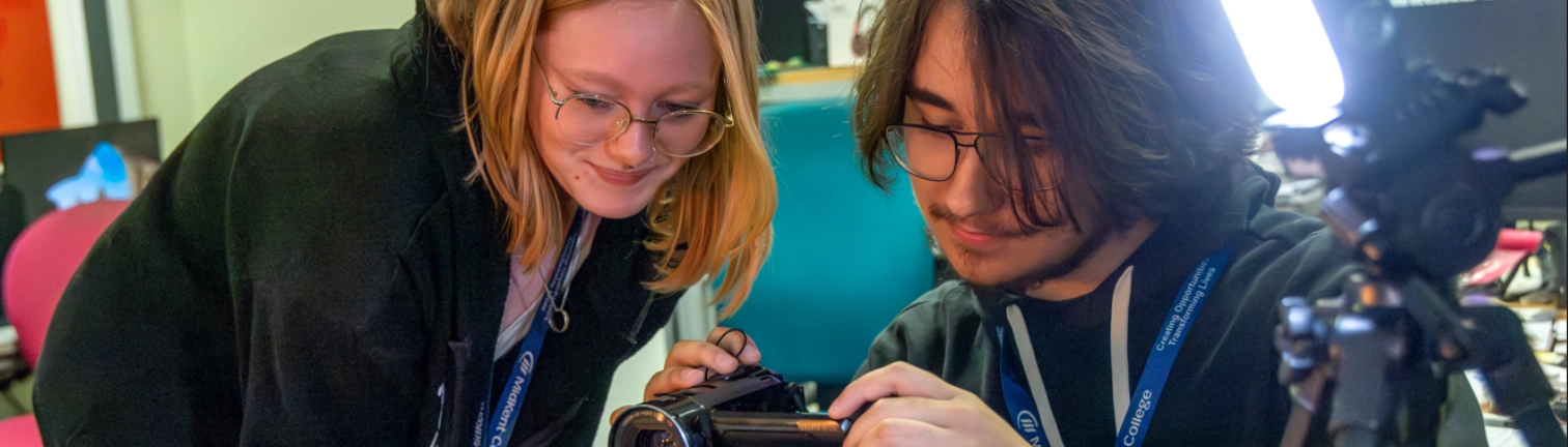 Creative media students looking at camera together