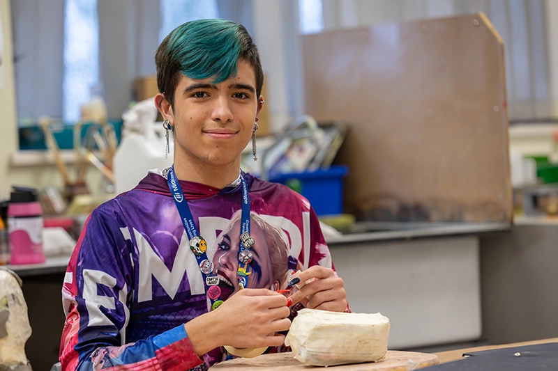 Student posing in the art workshop
