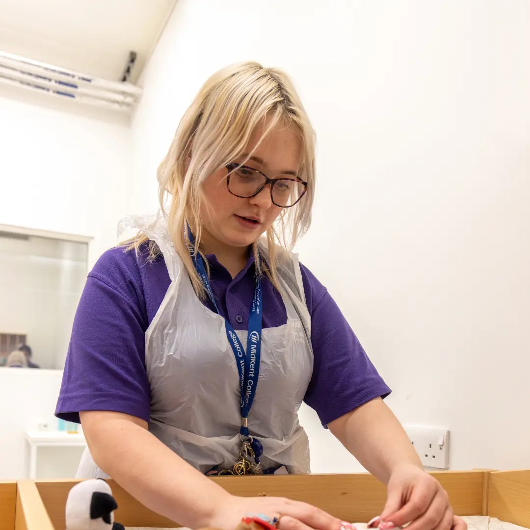 Student in Childcare classroom practising with arts and crafts