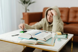 Student sat at desk with text books